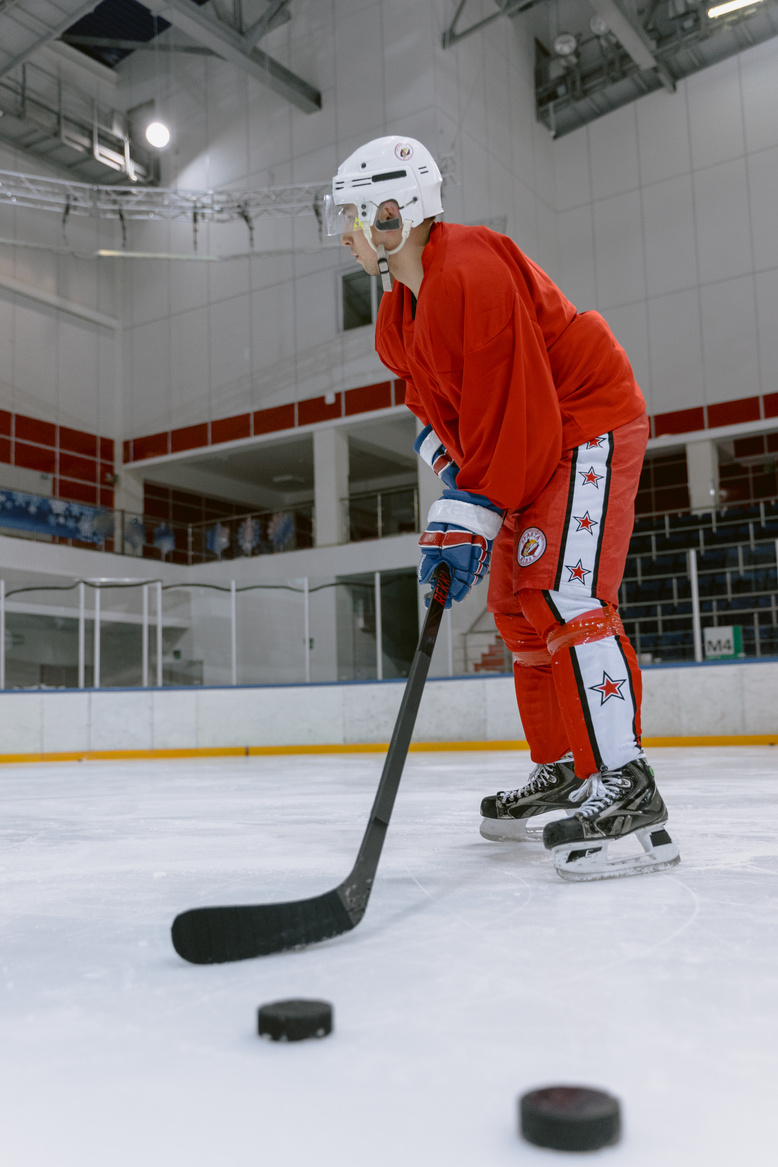 Hockey Player Wearing Uniform in Ice Rink